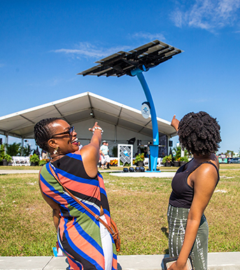 two female visitors point at the solar trees at Port Canaveral