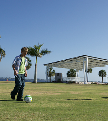 children playing under solar canopies at laishley park in punta gorda