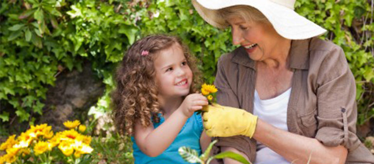 woman and girl picking flowers